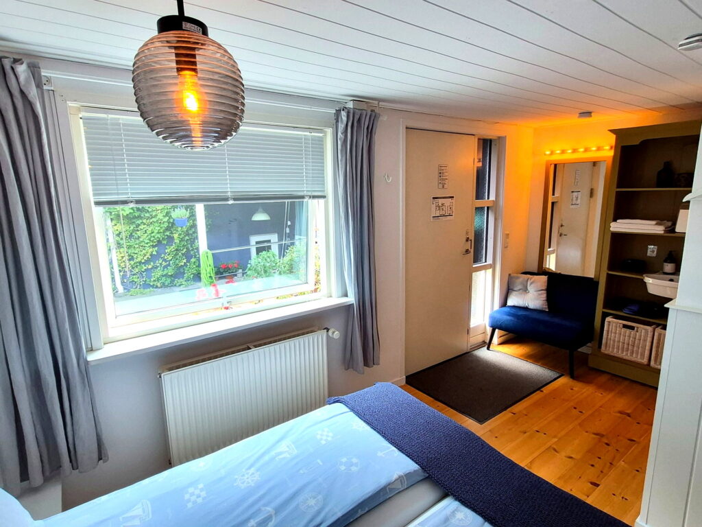 Cozy sitting area with natural light and garden view in Room 7 – The Annex.