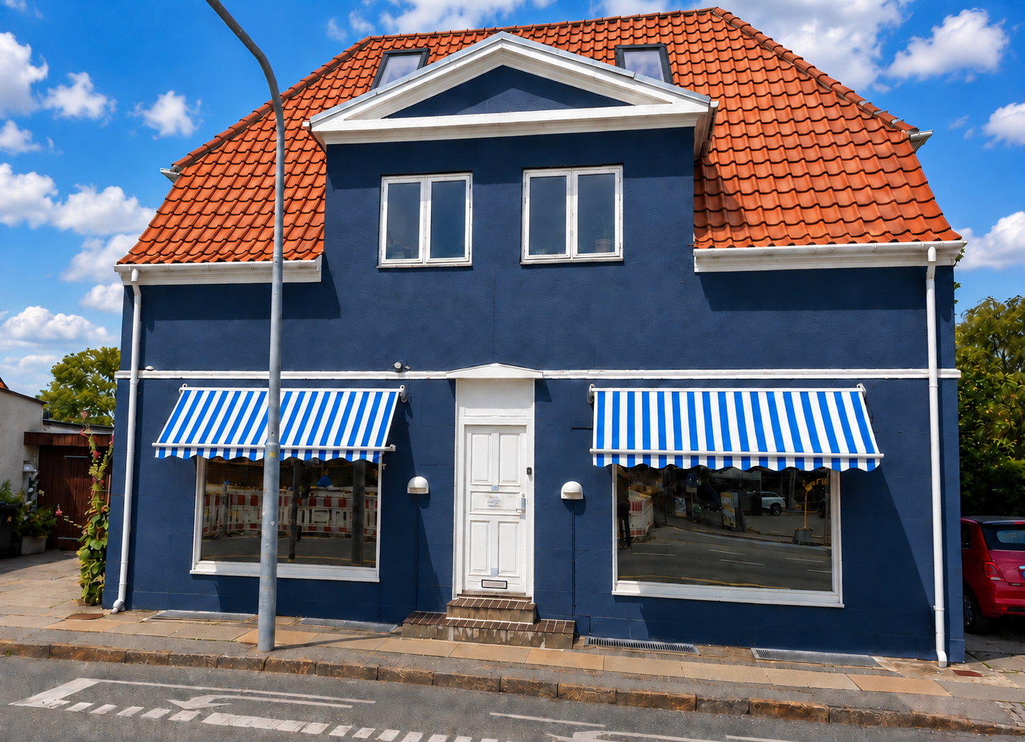 Concept illustration of a new red clay roof and two upper-attic Velux windows viewed from the street.
